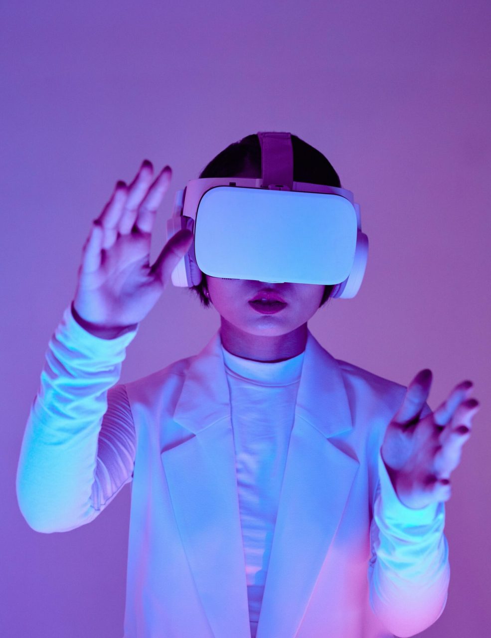 Woman in virtual reality headset interacting in a vibrant conceptual studio shoot.